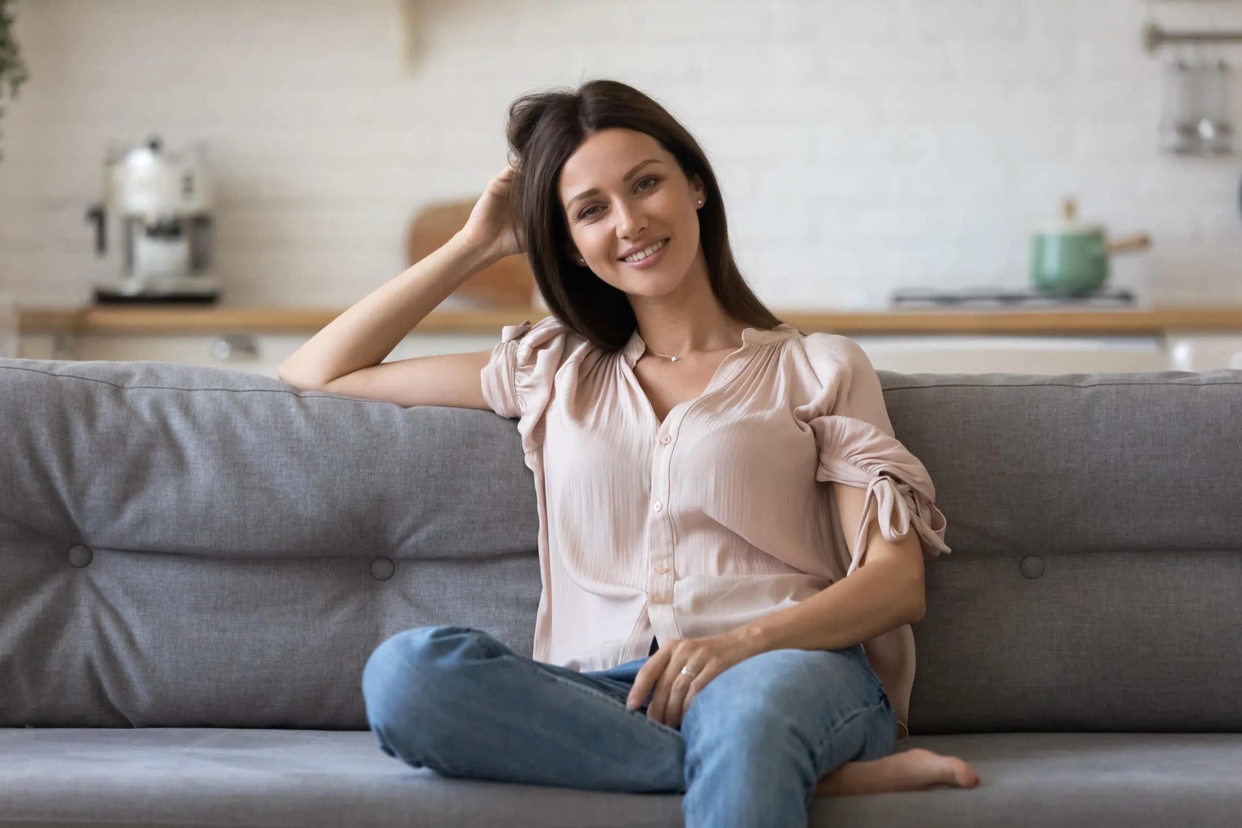 Portrait,of,smiling,young,woman,sit,relax,on,comfortable,couch