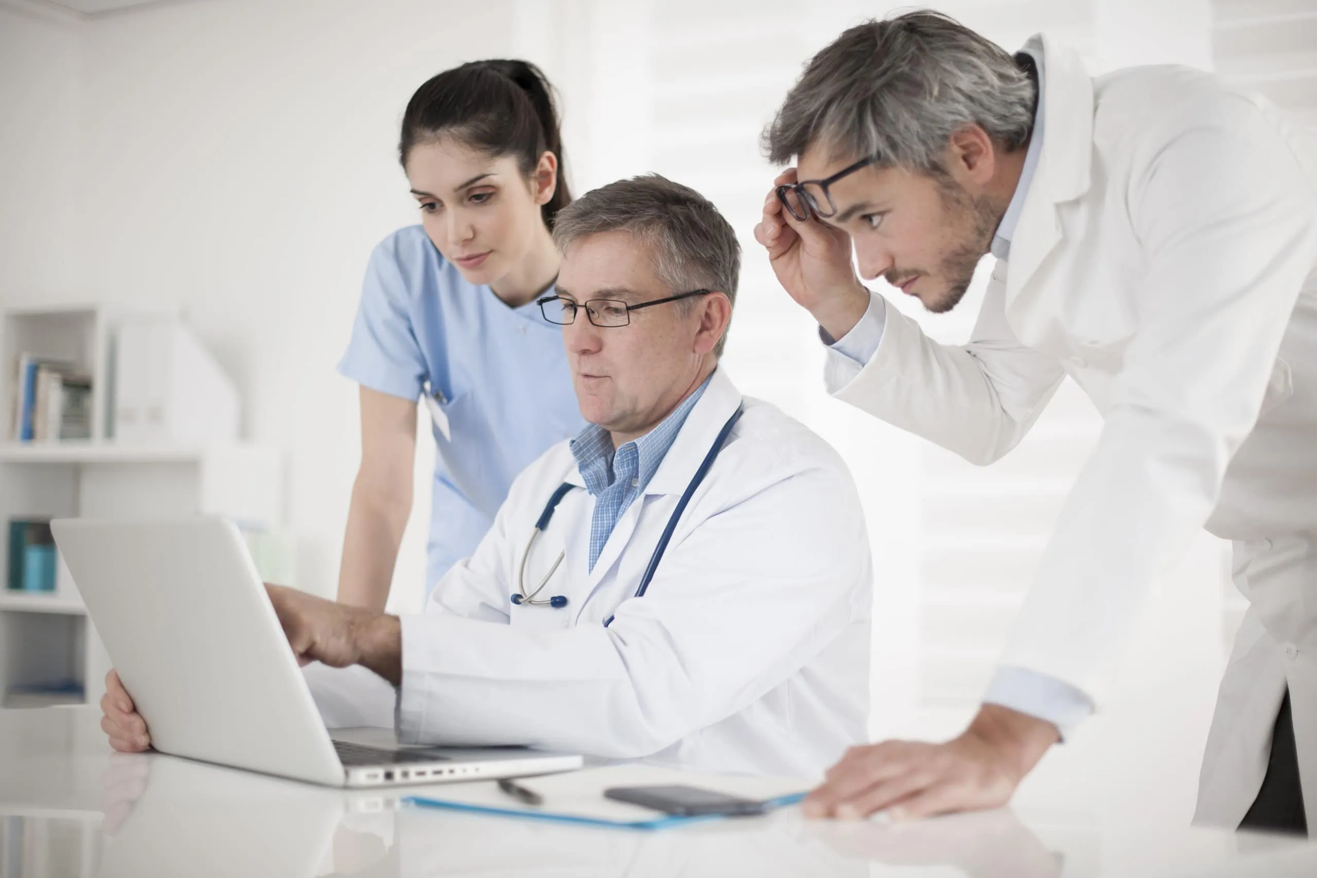 Medical,team,discussing,around,a,computer